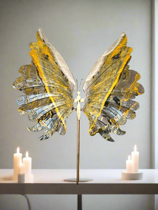 Decorative butterfly crystal sculpture with yellow wings on a white background